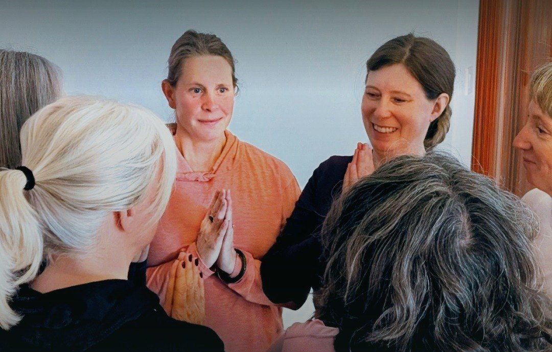 Women in a closing circle, hands in prayer